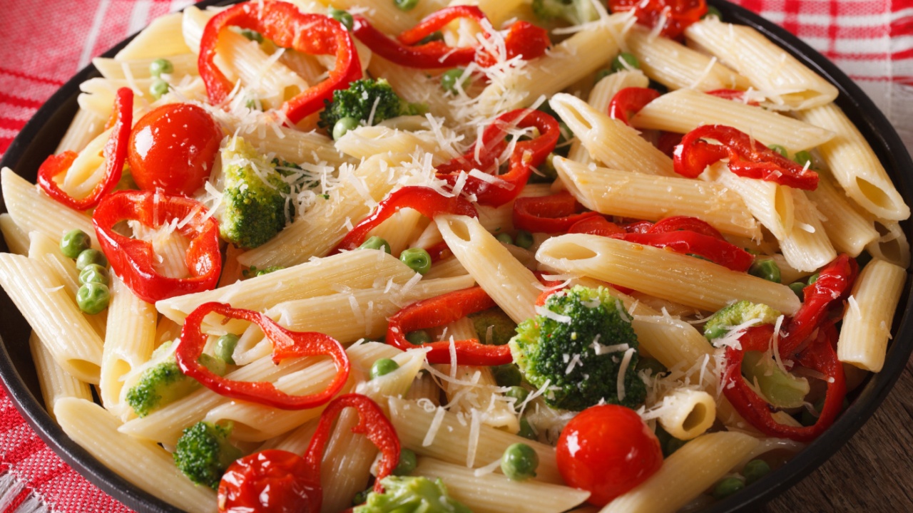 Pasta Primavera with vegetables close-up on a plate on the table. horizontal
