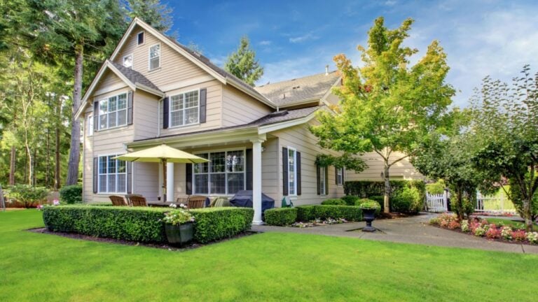 Large beige house with green grass