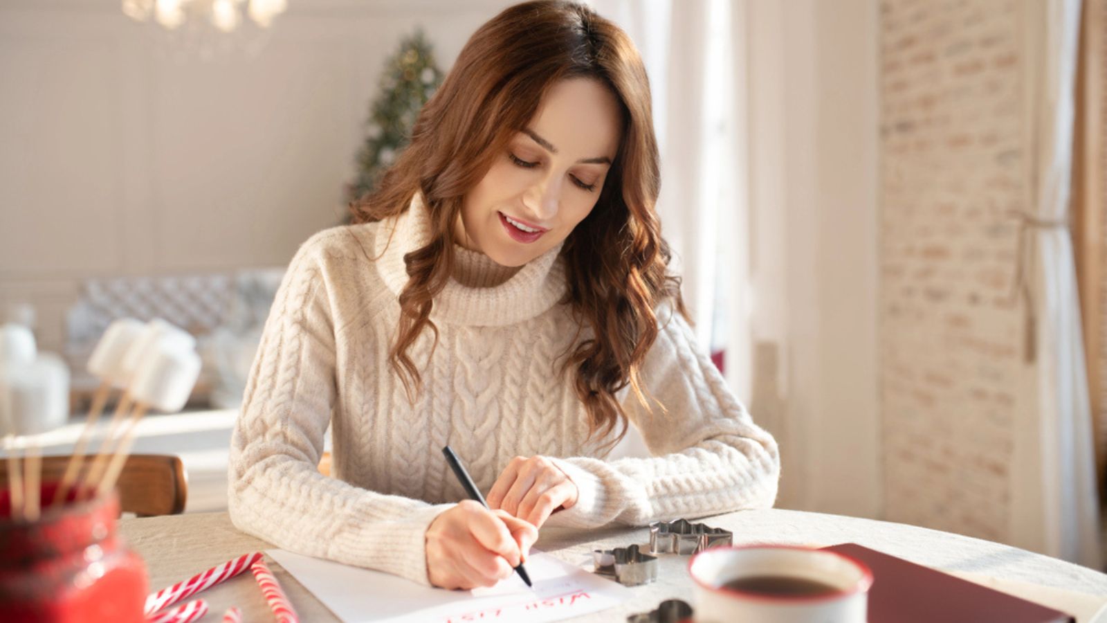 Beautiful long-haired woman writing a wish list