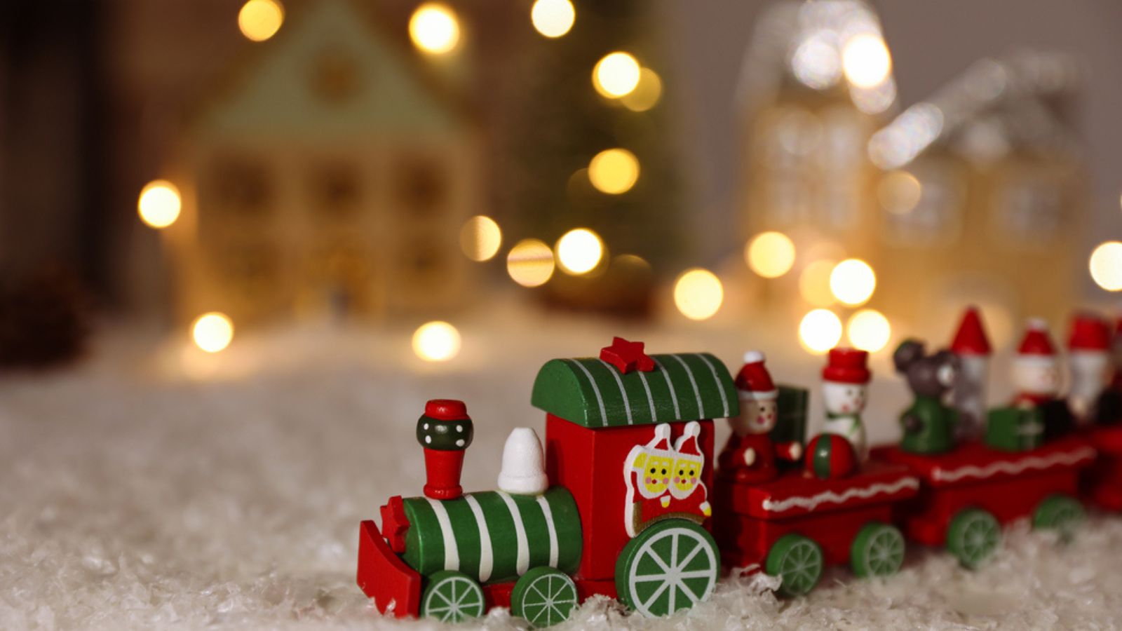 Bright toy train on artificial snow. Christmas atmosphere