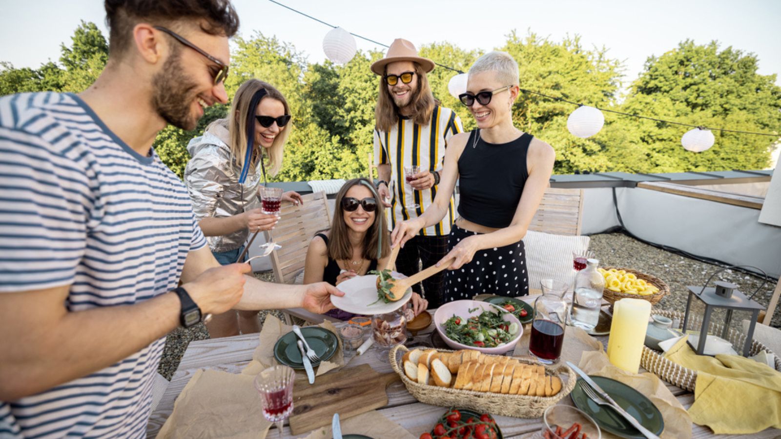 Friends sharing food at dinner outdoors