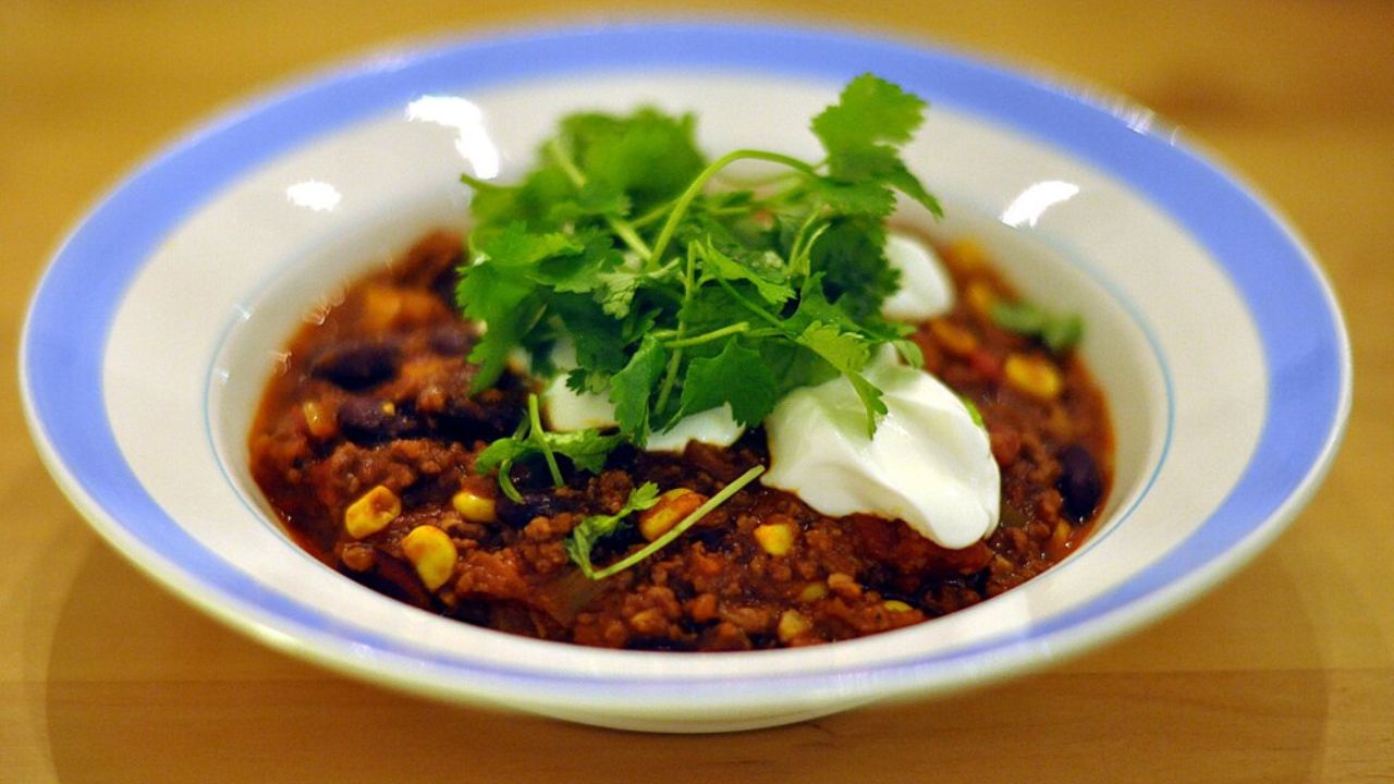 chili con carne with sour cream and cilantro
