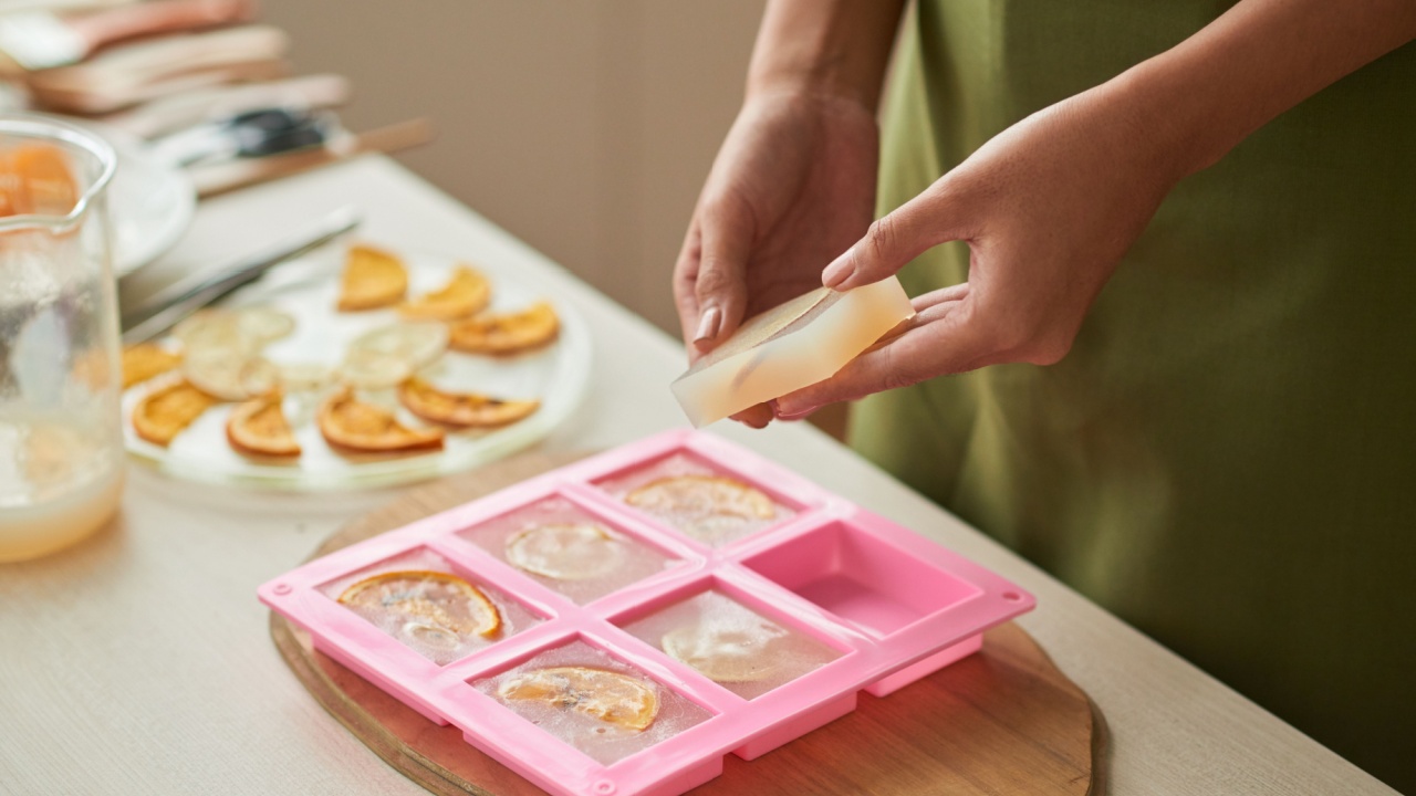 Woman taking soap bars out of plastic form