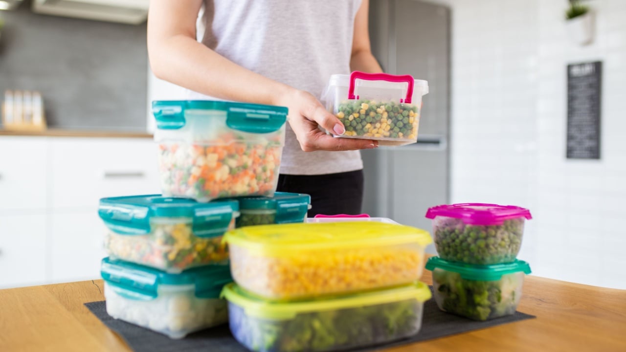 Woman preparing vegetables for winter in vacuum containers.