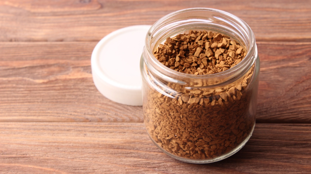 instant coffee in a glass jar on a wooden background.