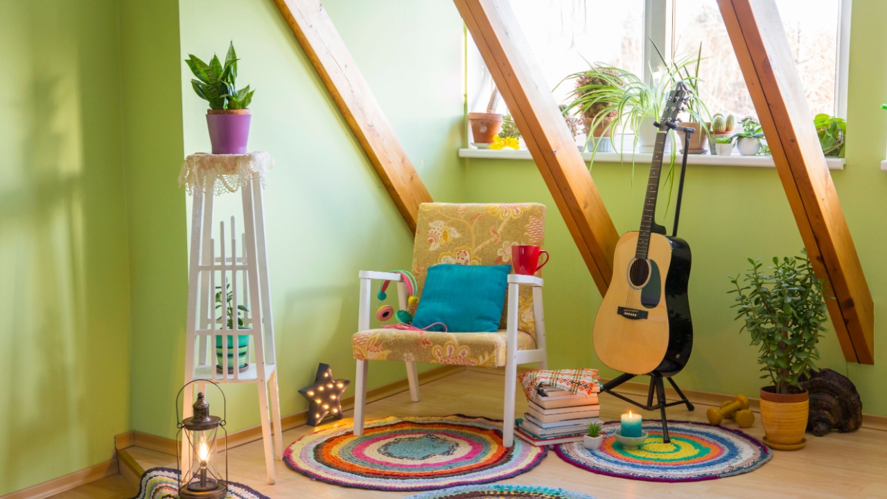 Modern maximalism or maximalist home decor interior design concept, different colorful things in home, vintage chair, flower stand, bright green wall.