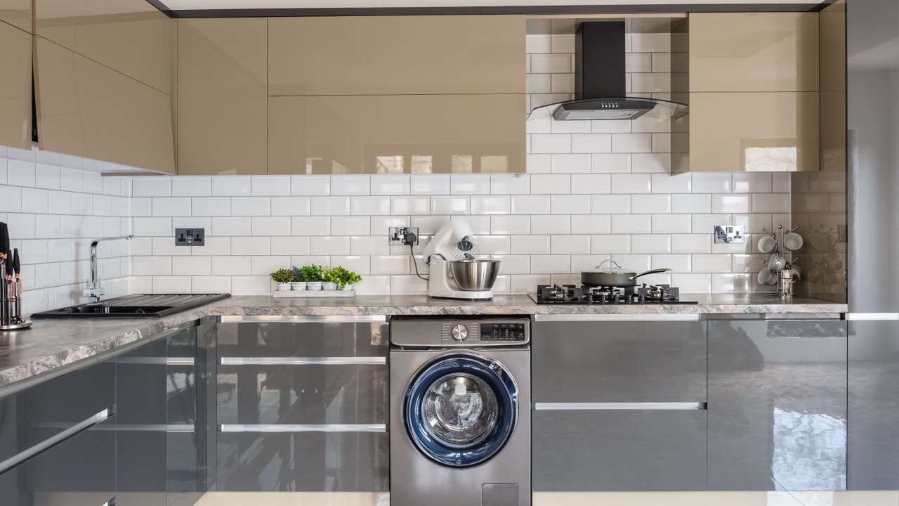 Spacious luxury well designed modern grey, beige and white kitchen with marble tiles floor