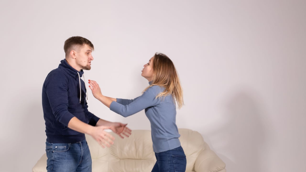 people, violence and abuse concept - angry man hitting woman