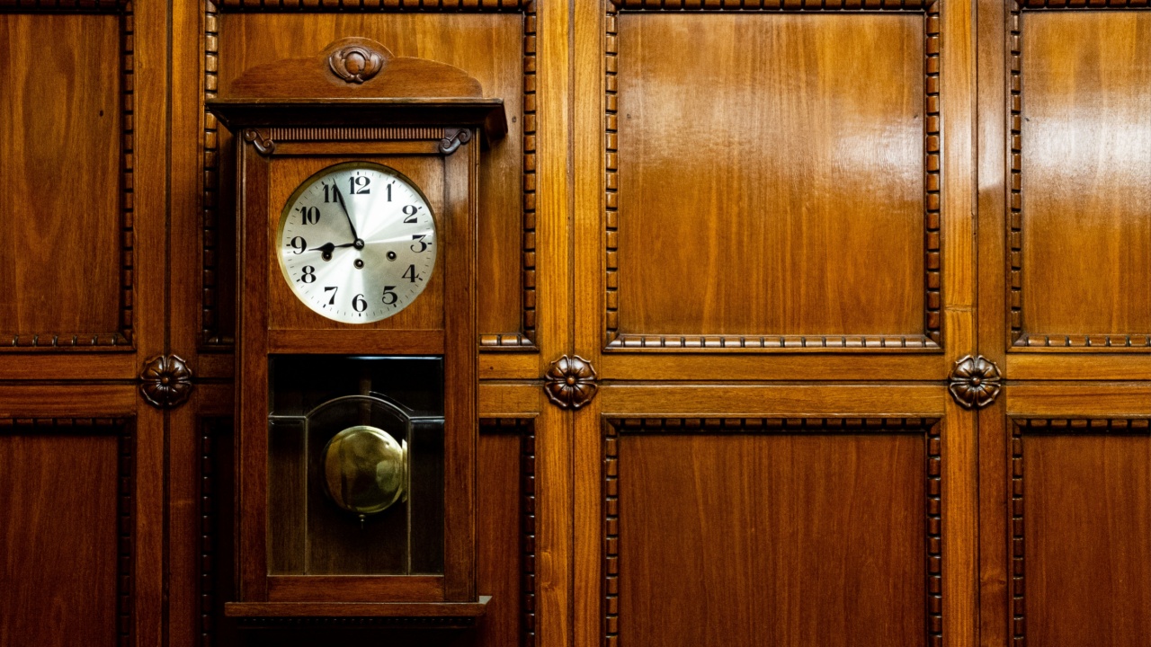 Grandfather clock in wooden case. wood Background. Pendulum wall clock.