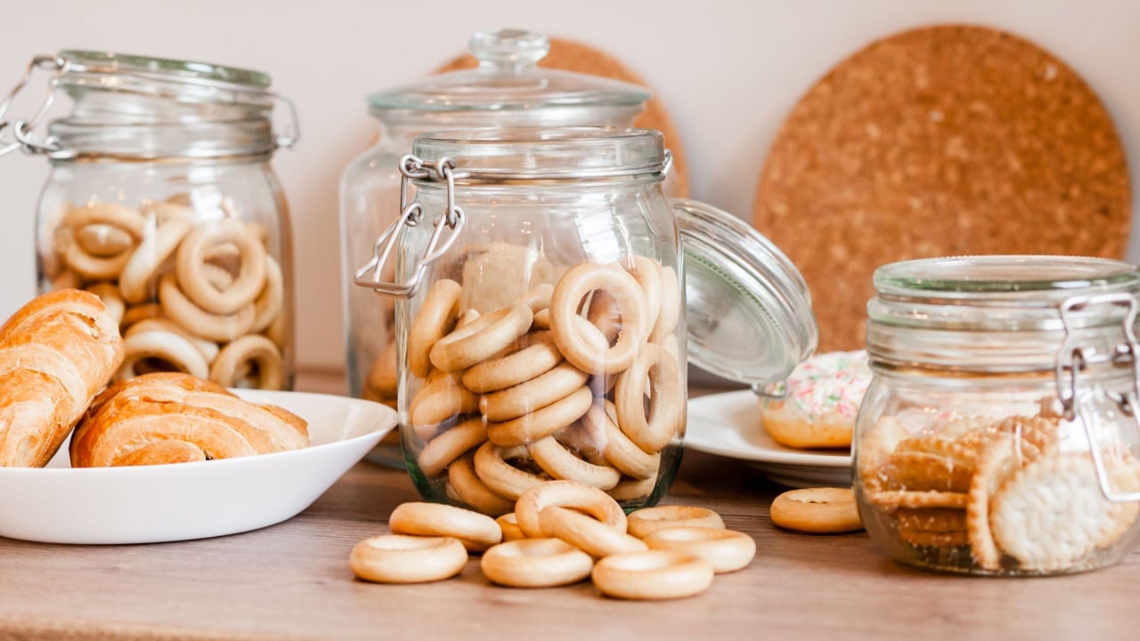 Snacks, bakery, cookies, bagels for tea on a wooden table background. bagels in a glass jar