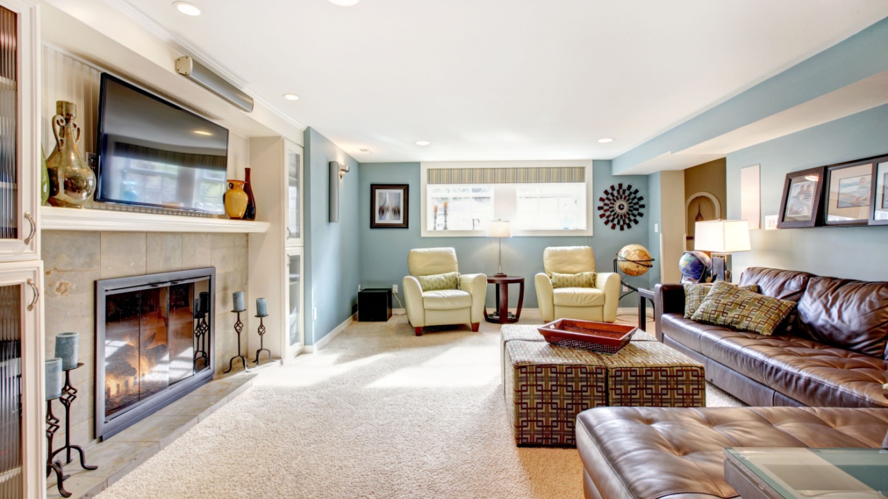 Light blue living room with leather furniture set, beige carpet floor, tv and fireplace