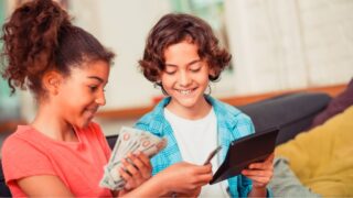 Managing money. A boy and a girl learning to plan a budget