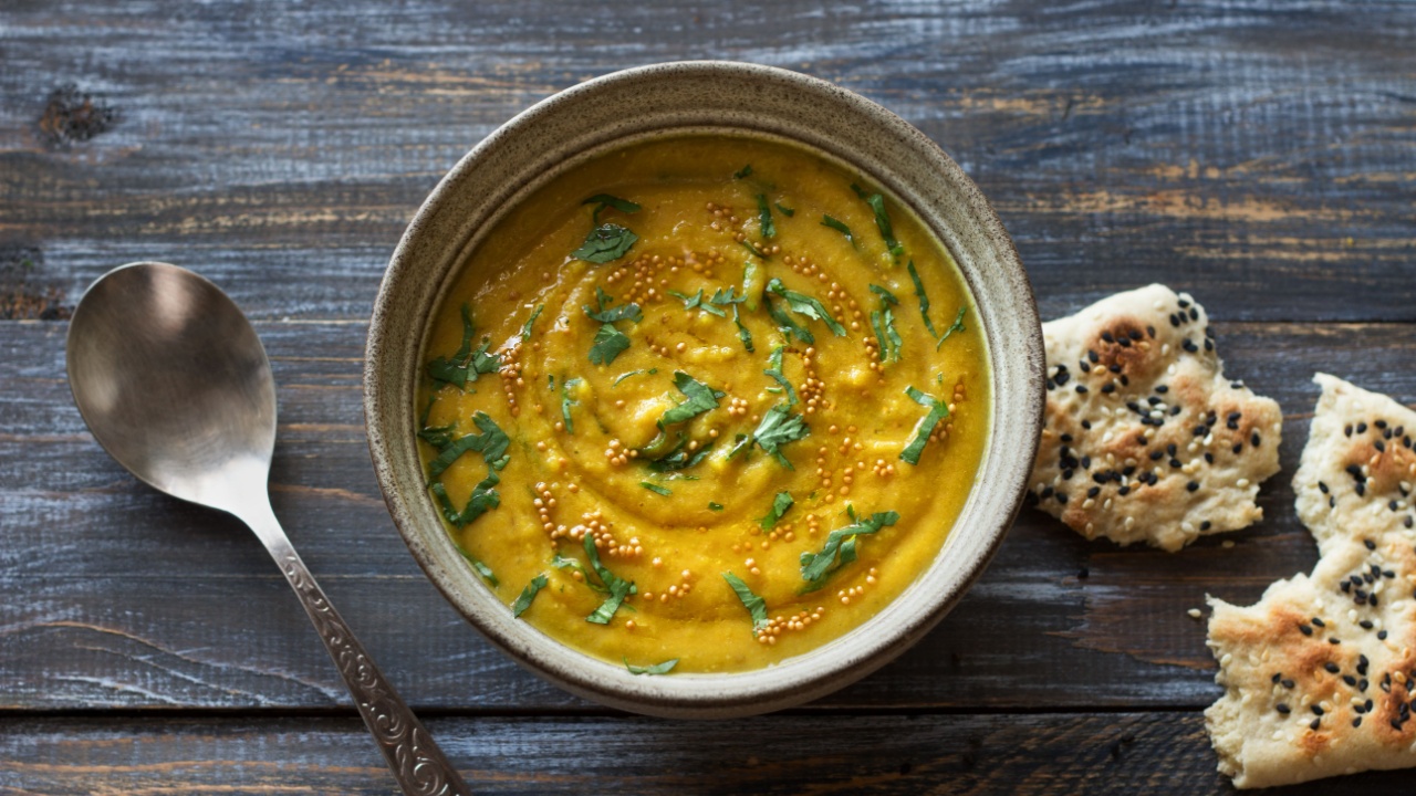 Indian lentil masurdal soup with turmeric, ginger and herbs, top view