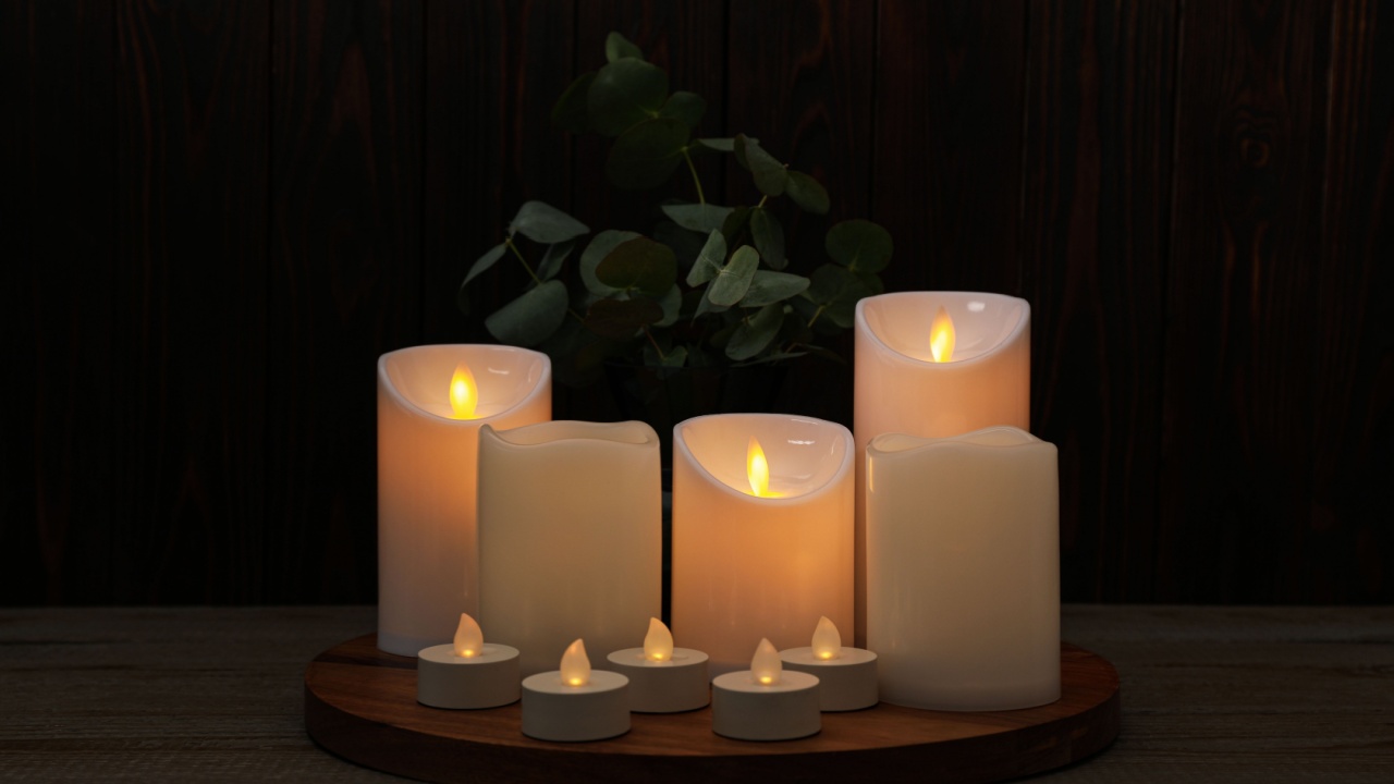 Beautiful decorative LED candles on wooden table