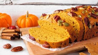 Fall pumpkin bread. Slices close up against a white table scene background.