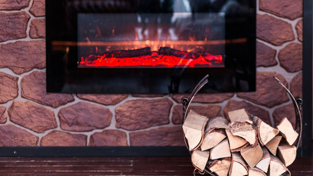 Decorative fireplace with firewood and fake fire. Interior decor. Photo