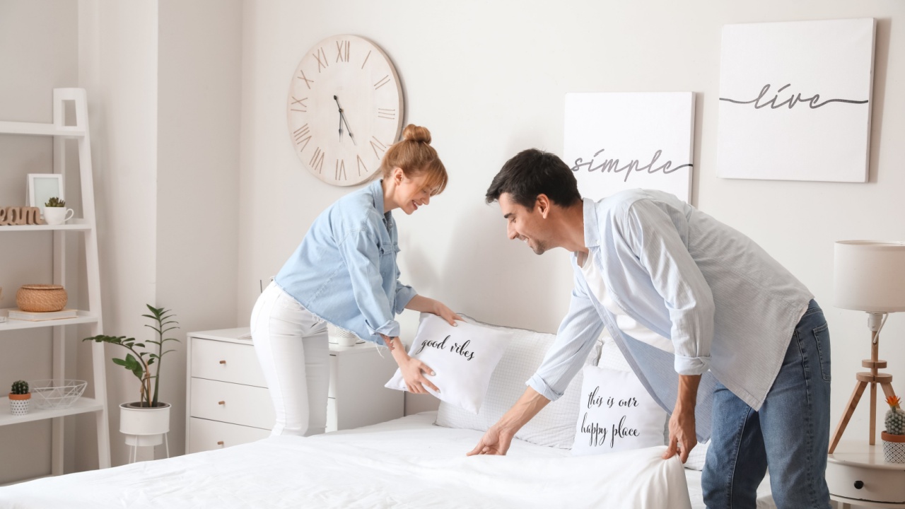 Young couple making their bed