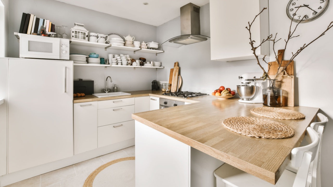 Delightful small kitchen area with wood worktop in daylight