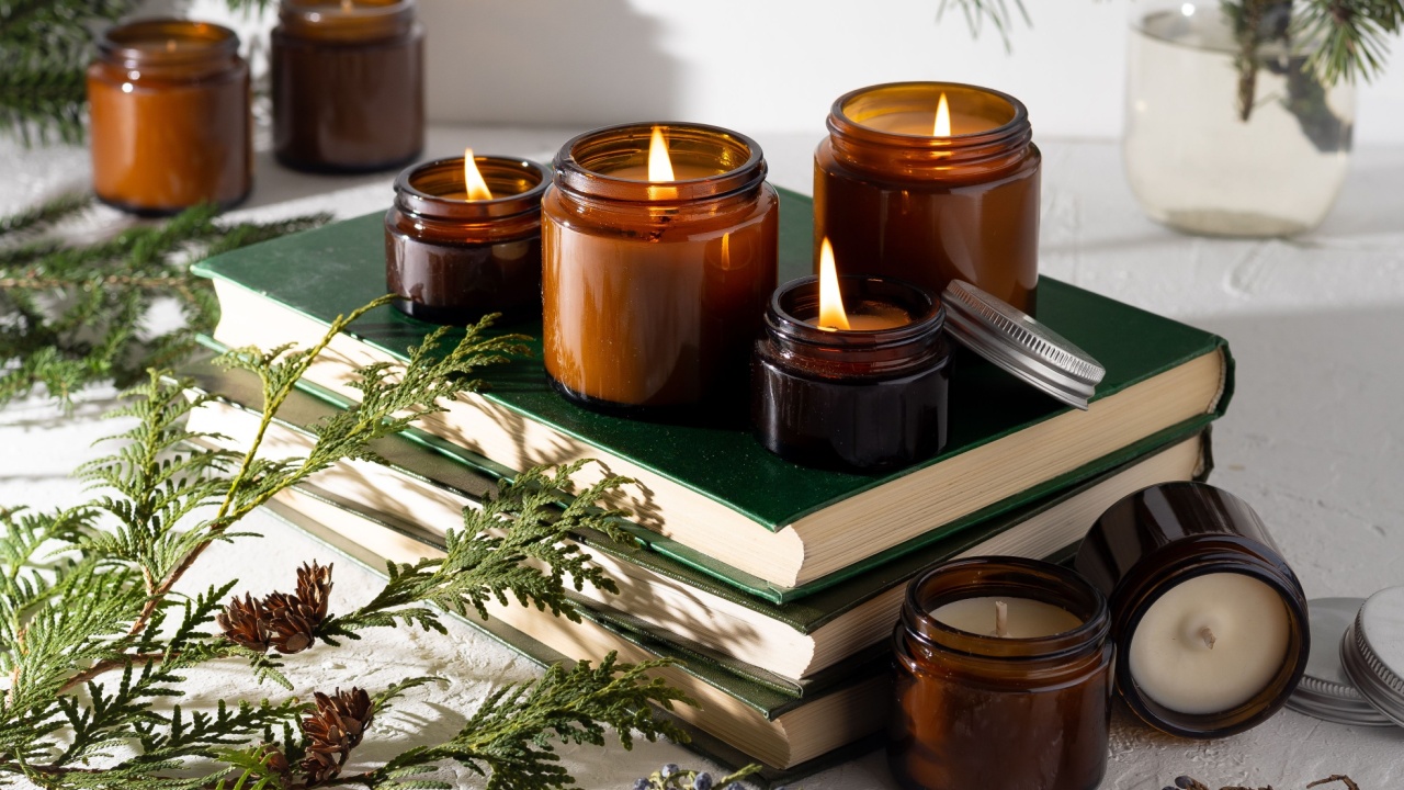 A set of different aroma candles in brown glass jars. Scented handmade candle. Soy candles are burning in a jar. Aromatherapy and relax in spa and home. Still life. Fire in brown jar