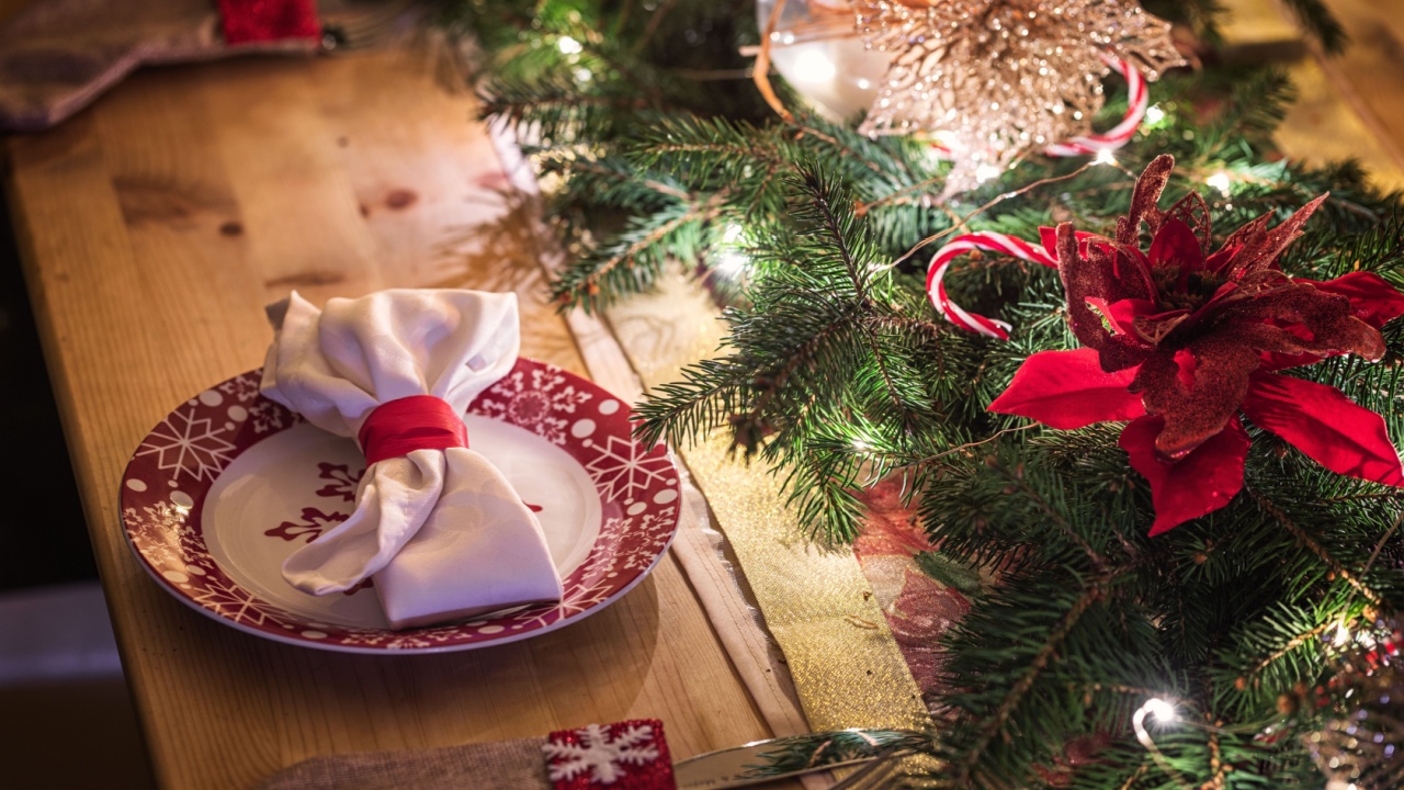 Elegant table setting for Christmas dinner with candles and Christmas decorations