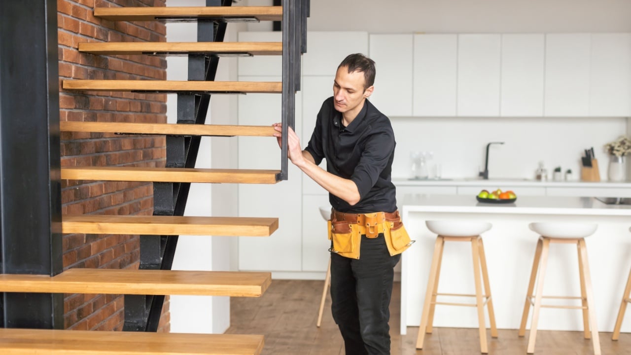 the worker is repairing the stairs
