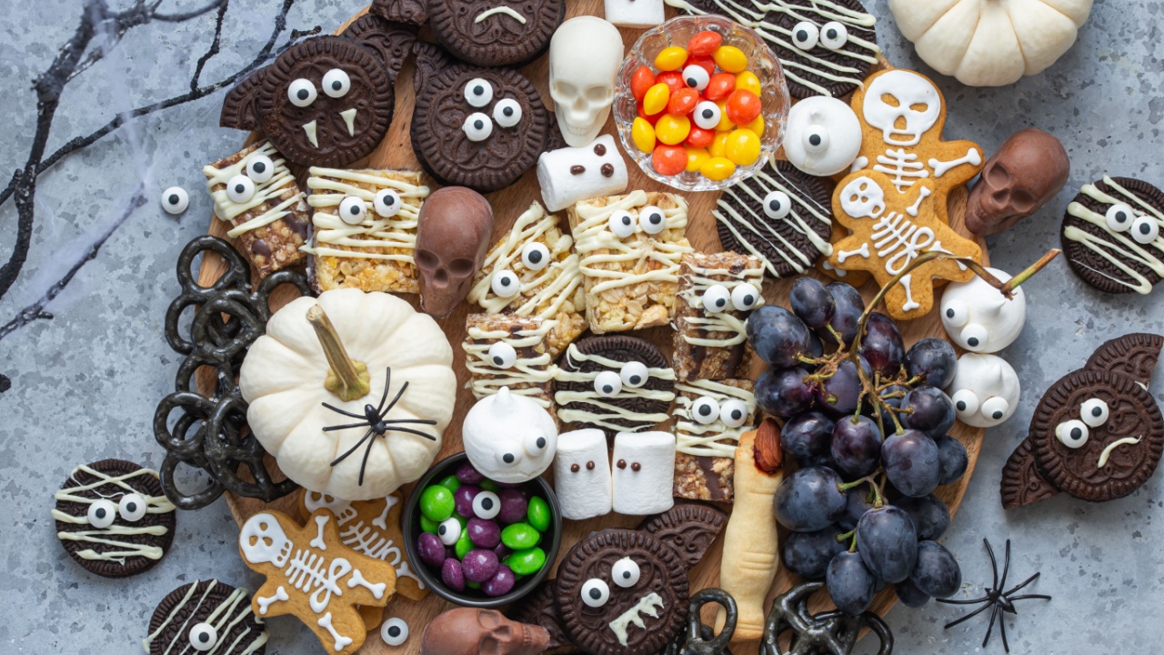 Charcuterie Halloween dessert platter, spooky and funny trats board, top view