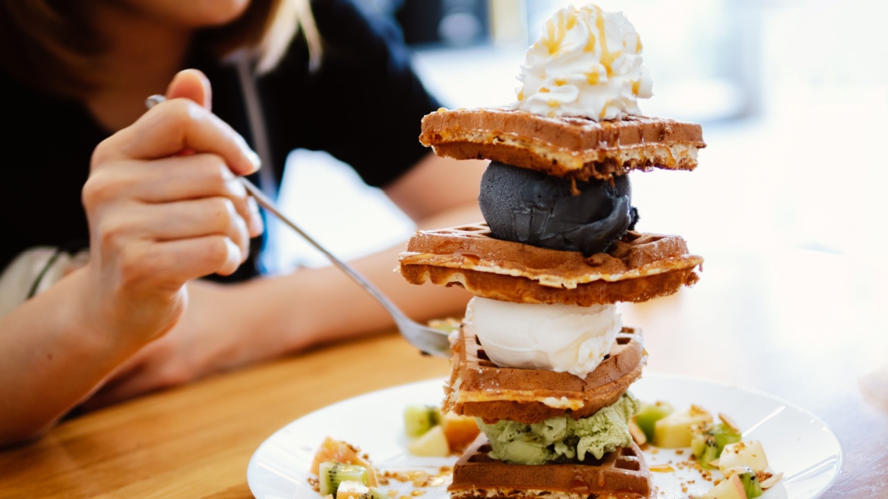 Waffles, gaufre or wafel or waffle with fruit, Ice-cream and topping. Sweet Indulgence. Freshly Baked ice cream Waffle with Delicious Toppings on Wooden Table.