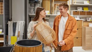 Cheerful man and woman couple deciding to buy craft furniture for home