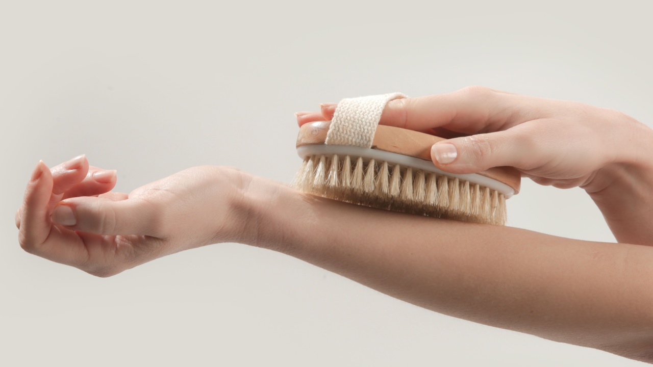 Dry body brush, Woman dry brushing body to reduce cellulite, detoxify the lymphatic system, and achieve beautiful smooth skin. Dry skin brushing as part of morning health and energy routine.