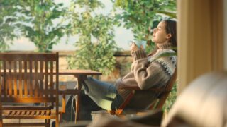 Profile of a woman in a house terrace drinking coffee and breathing