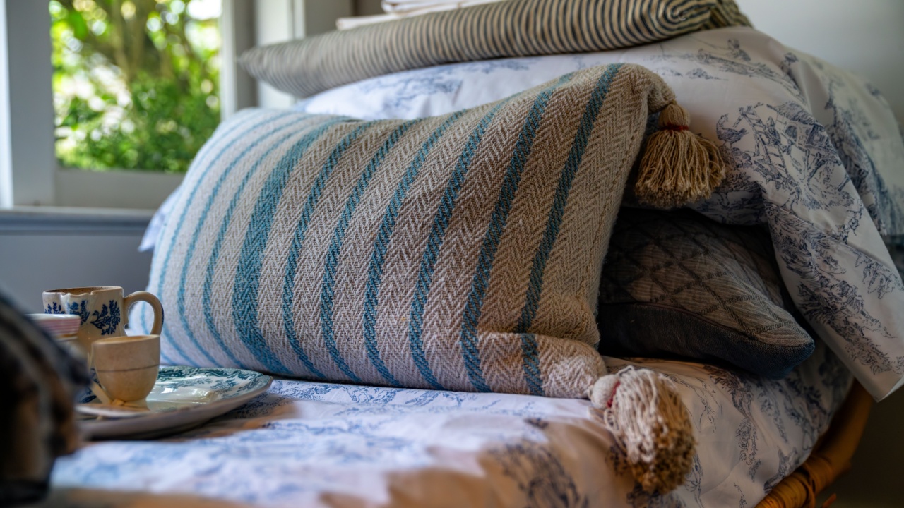 Close up of a throw pillow on a bed, old vintage look like style.