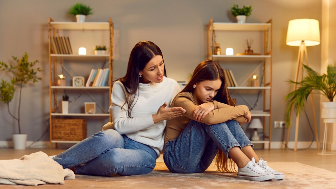 Mother comforting sad child. Worried mom and mad, distressed kid daughter sitting on floor, talking about psychology, mental health, trauma, negative feelings, trying to reconcile after disagreement