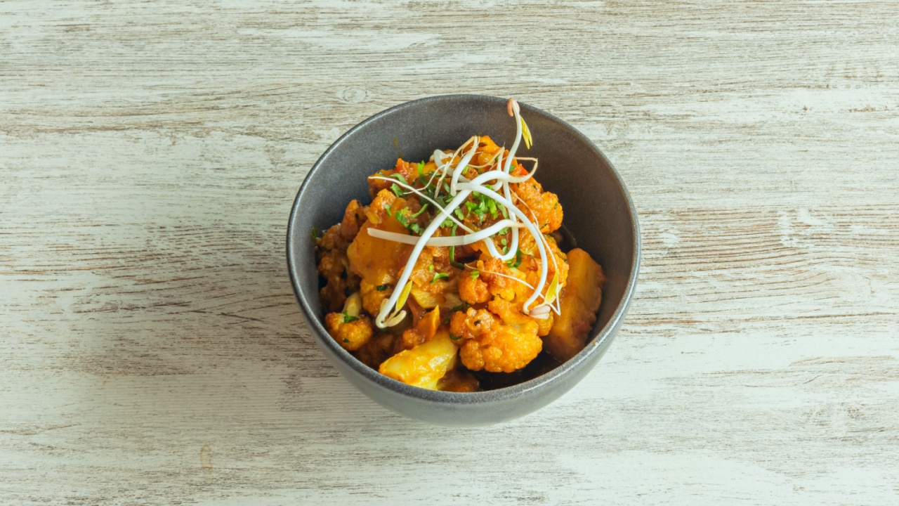 A bowl with a delicious Hindu recipe with aloo gobi cauliflower