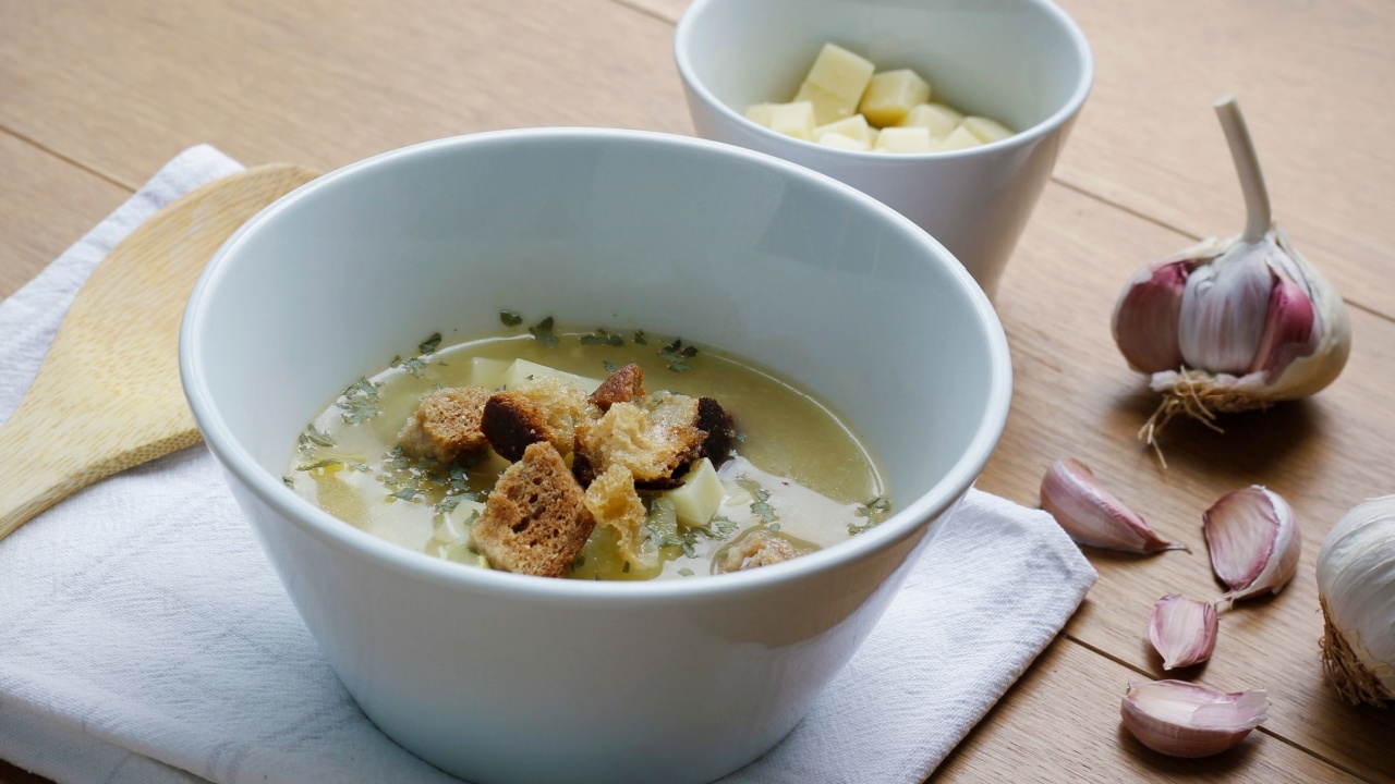 Bowl of a traditional Czech and Slovak garlic soup (called cesnecka or oukrop) cooked from broth, garlic, potatoes, cumin and egg and served with cheese and croutons. Traditional Czech, Slovak dish.