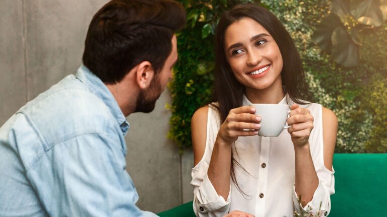 Happy Woman Talking Flirting With Boyfriend On Romantic Morning Date Sitting In Coffee Shop. Selective Focus