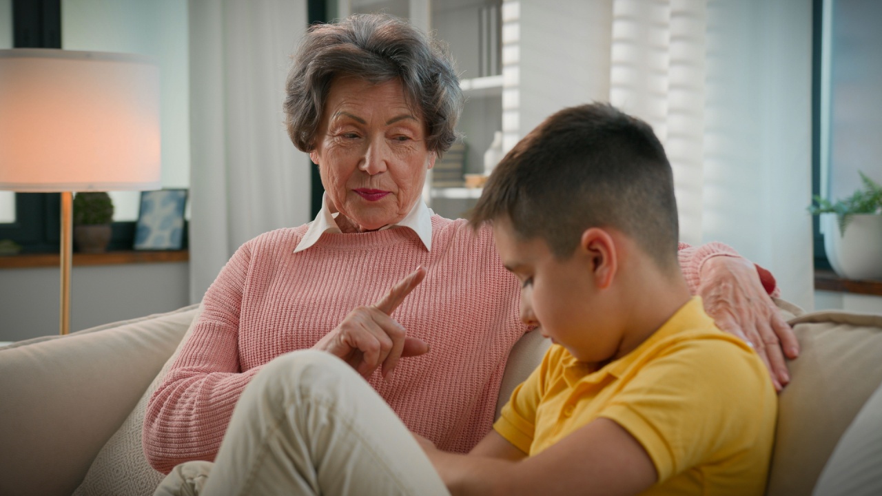 Serious strict grandmother scolding offended grandson at home couch senior woman grandma punishing disobedient grandchild kid boy bad behavior demand discipline explain family conflict two generation