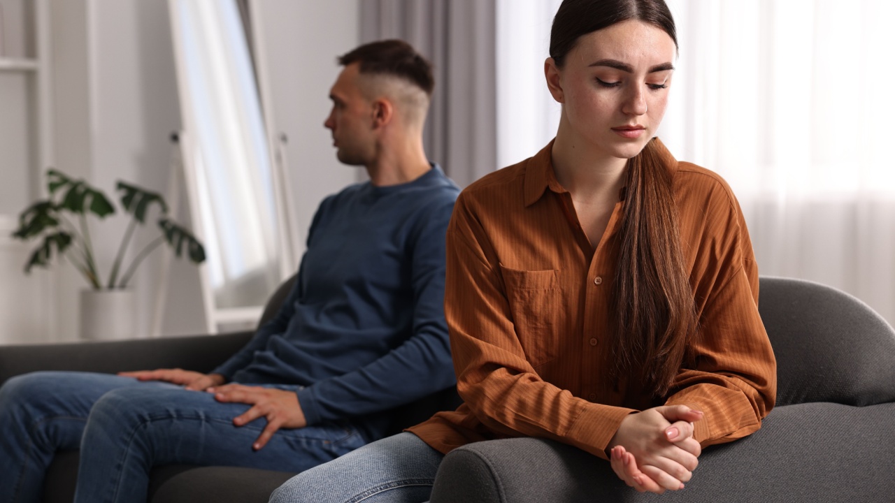 Offended couple ignoring each other at home, selective focus