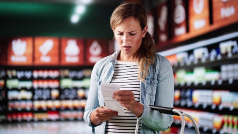 Customer At Grocery Store Or Supermarket With Receipt. Cost Inflation Shock