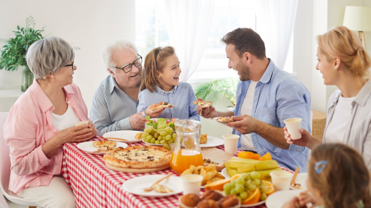 children brother and sister playing chess game with grandparents old retired family