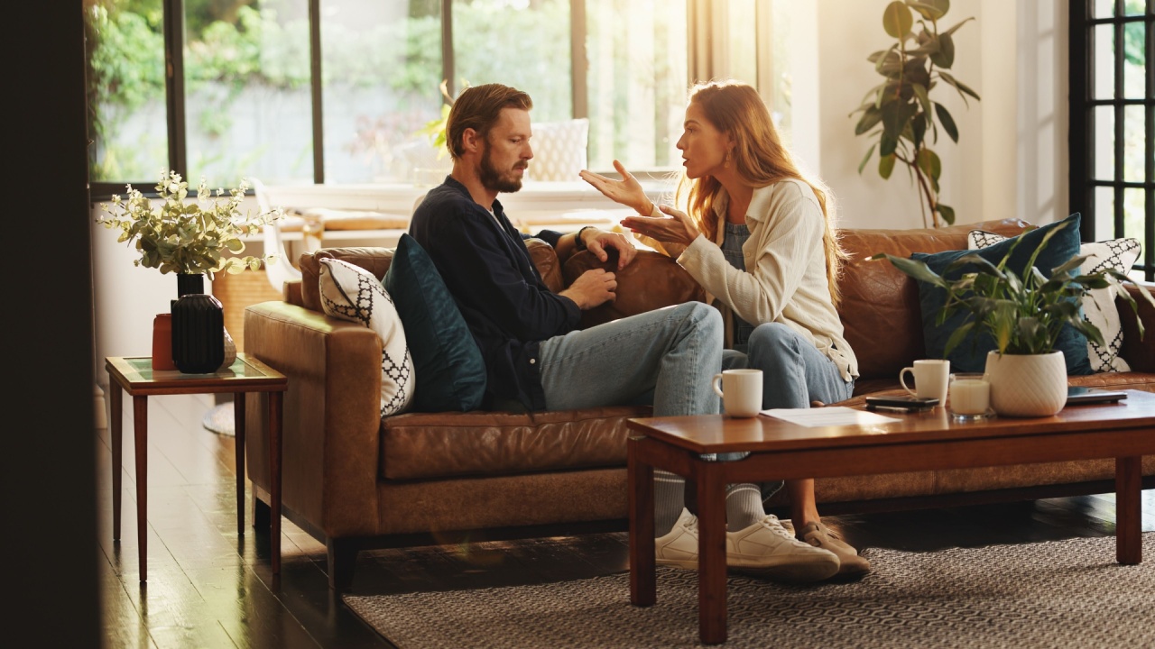 Angry, argue or couple fight in home with cheating, affair or liar on couch with marriage or fail. Talk, frustrated or upset people on sofa in toxic relationship with divorce risk, stress or mistake