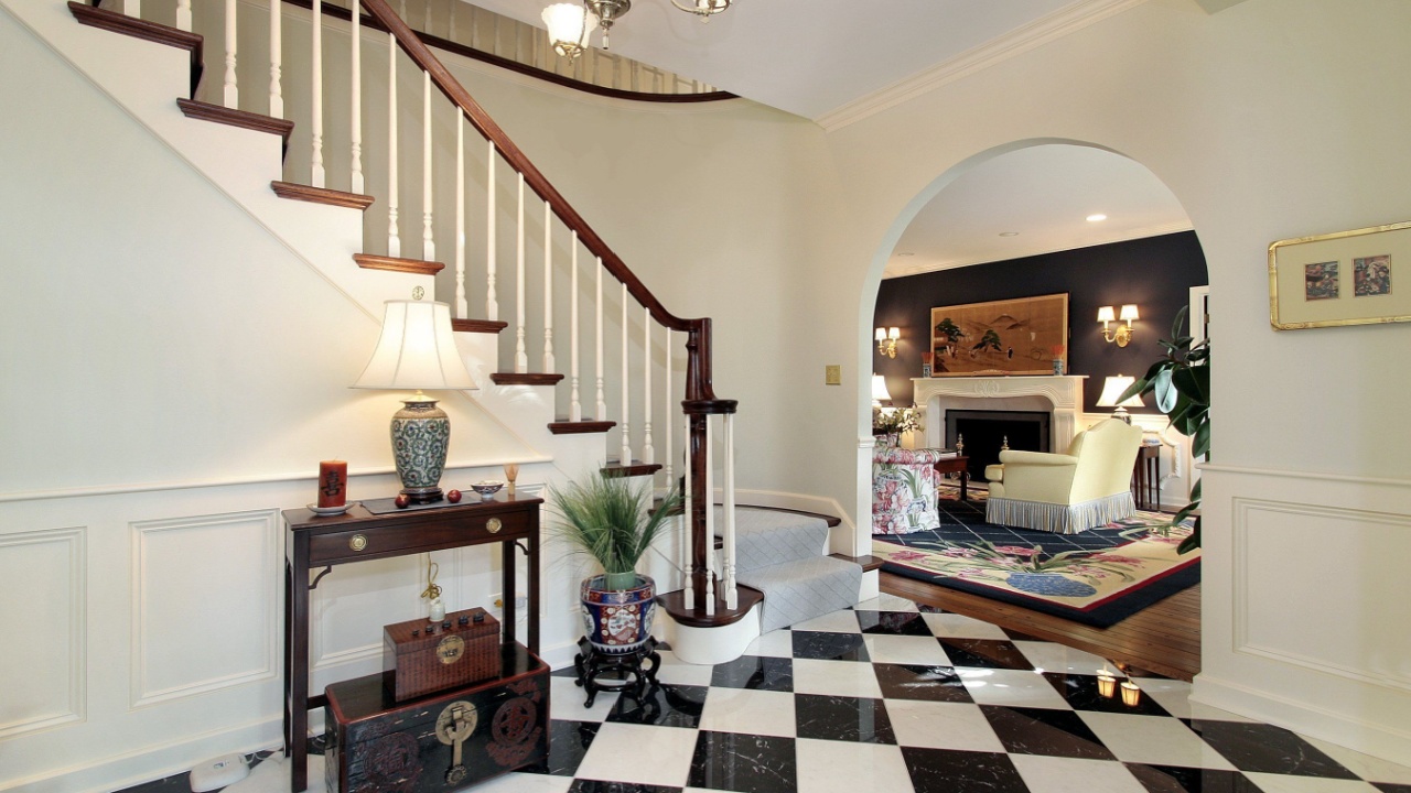 Checkerboard floor in foyer with stairway