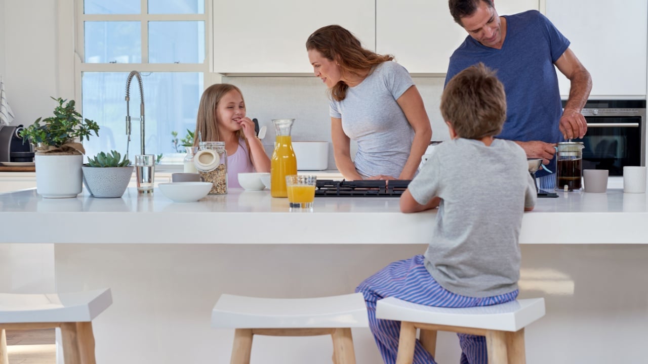 happy smiling caucasian family in the kitchen preparing breakfast