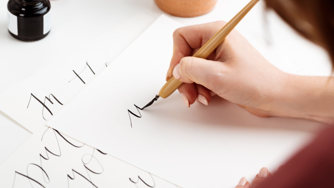 Girl writing calligraphy on postcards. Art design.