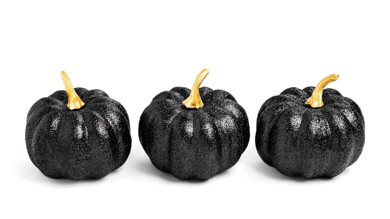 Three Black Shiny Decorative Pumpkins. Halloween decorations.