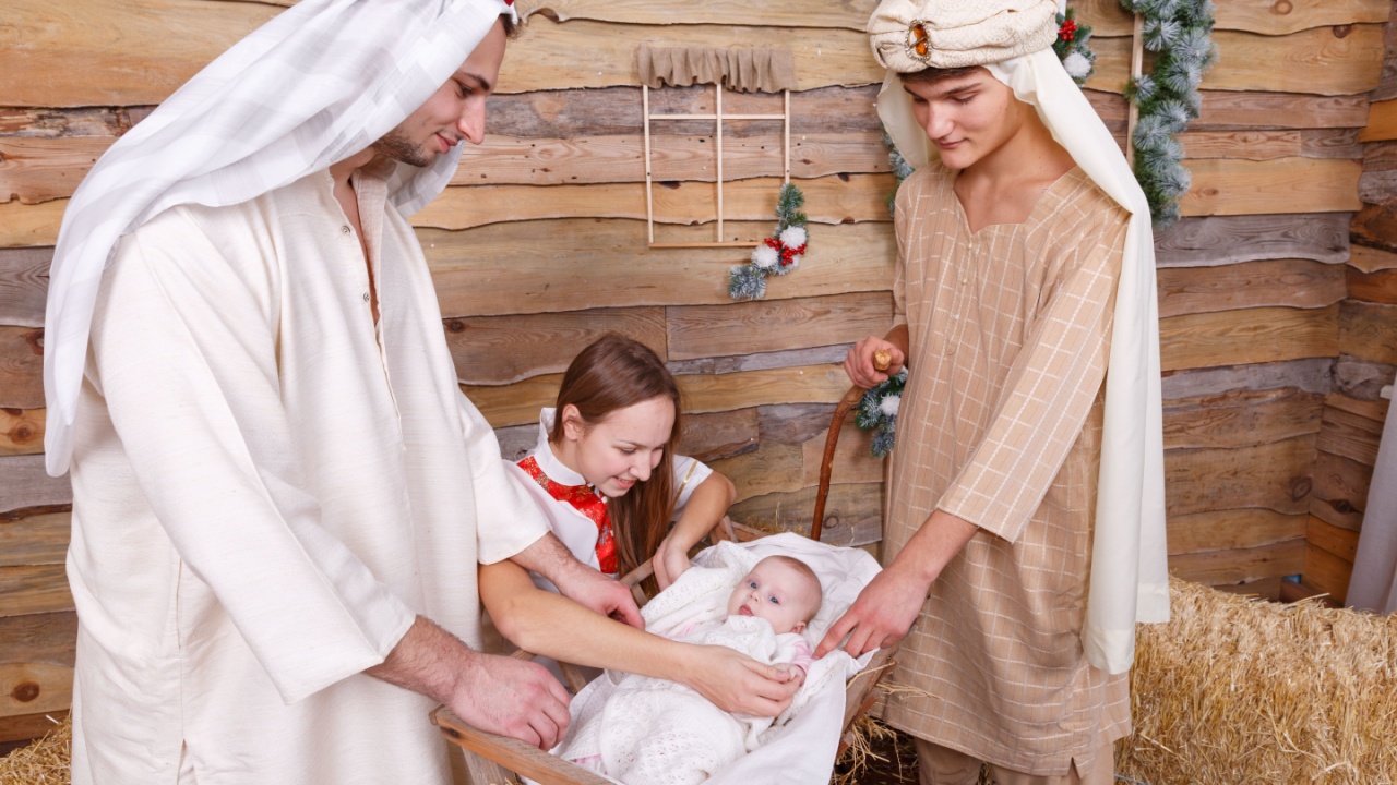 Religious people stand on a nursery with a child