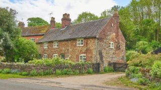 Traditional village cottage and driveway in Ticknall, Derbyshire, England.