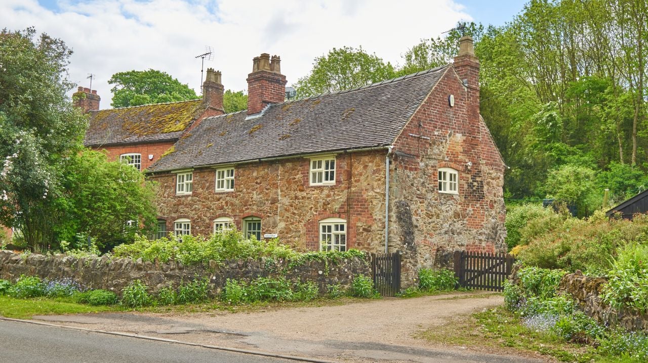 Traditional village cottage and driveway in Ticknall, Derbyshire, England.