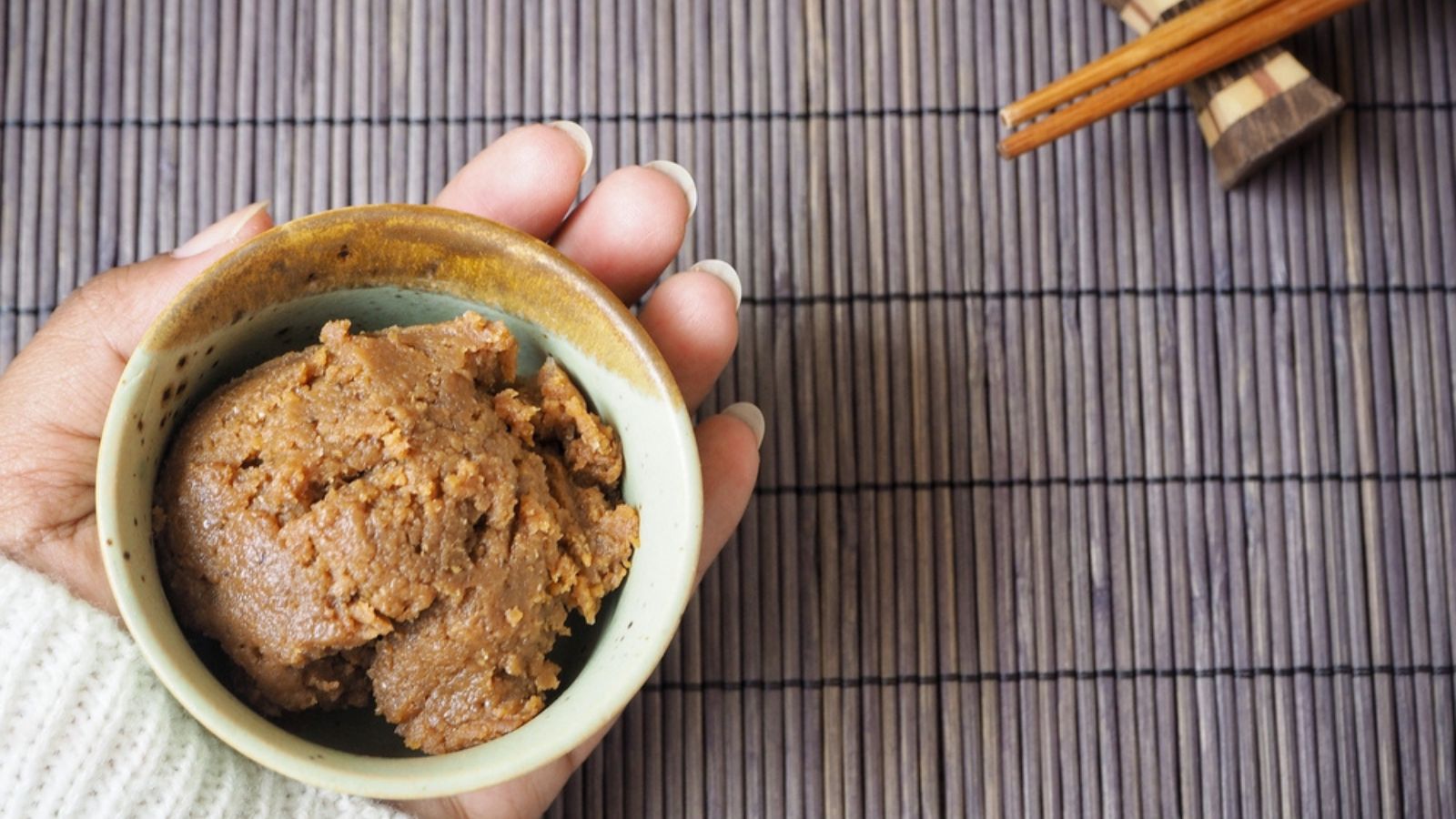 Traditional japanese Miso paste in ceramic bowl on wooden background