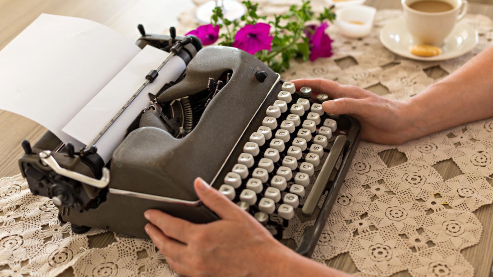 lace tabletop with a typewriter and flowers vintage