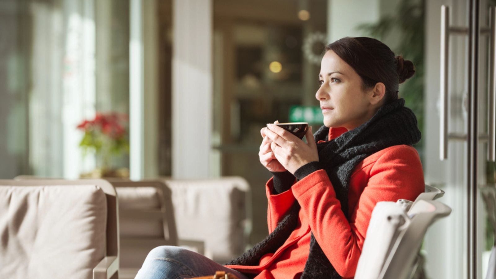 Woman relaxing at home winter drinking cup of tea